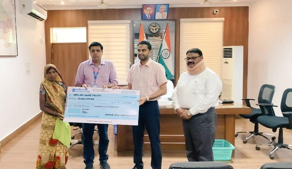 Beneficiary received check under Pradhan Mantri Jeevan Jyoti Yojana